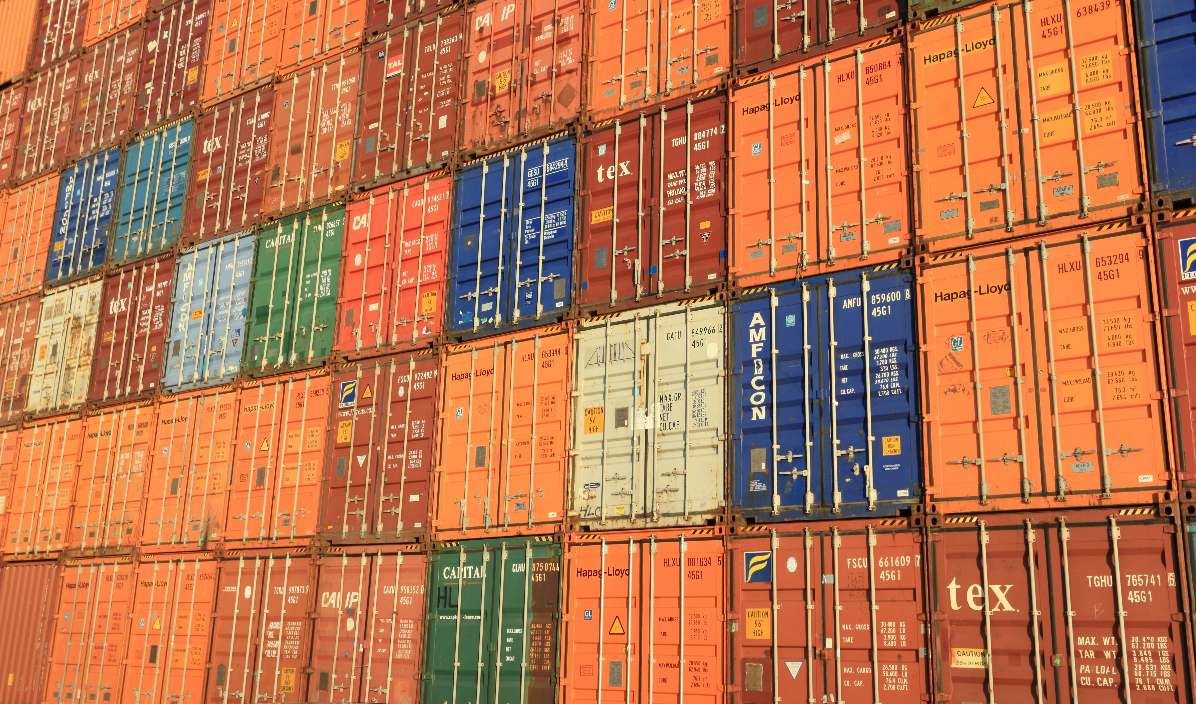 Stacked shipping containers representing international trade and logistics